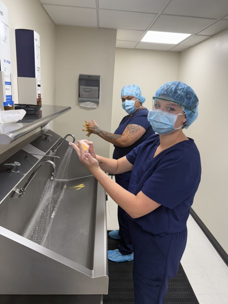 Surgical tech student scrubbing in at the surgical sink
