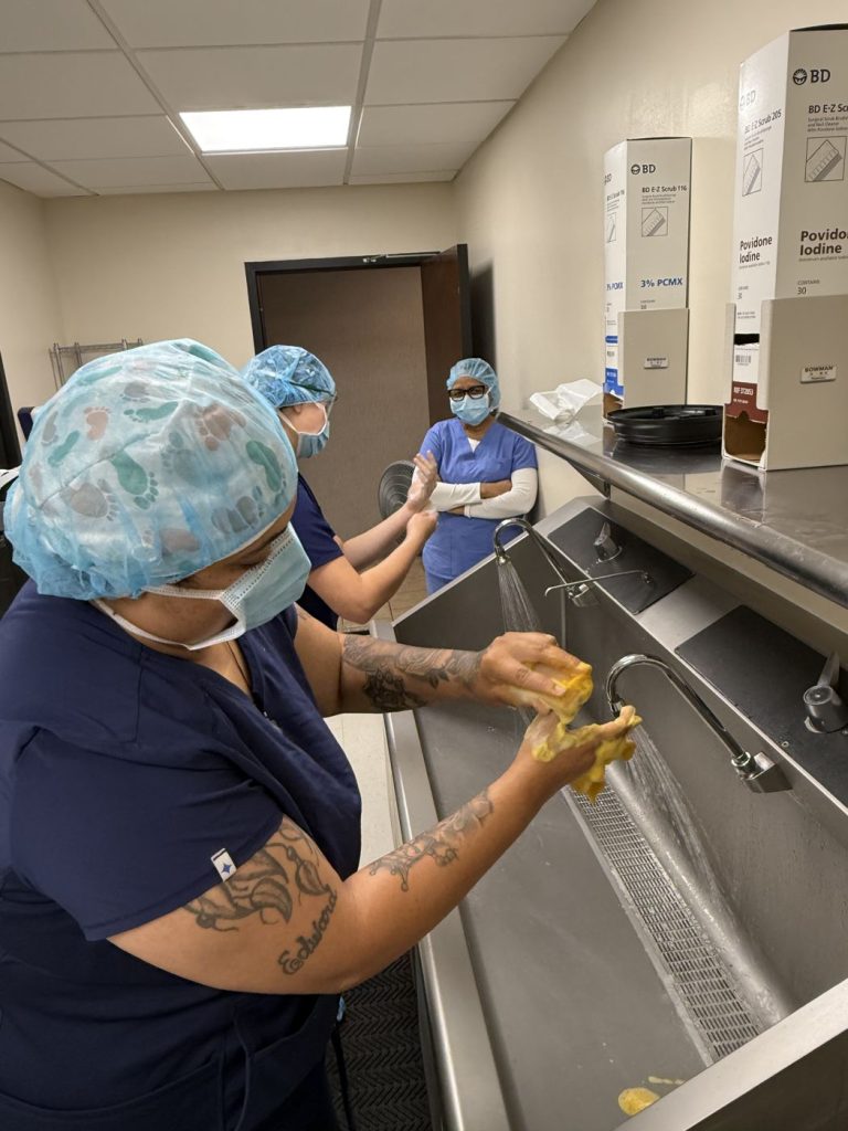 Surgical tech students performing a surgical hand scrub
